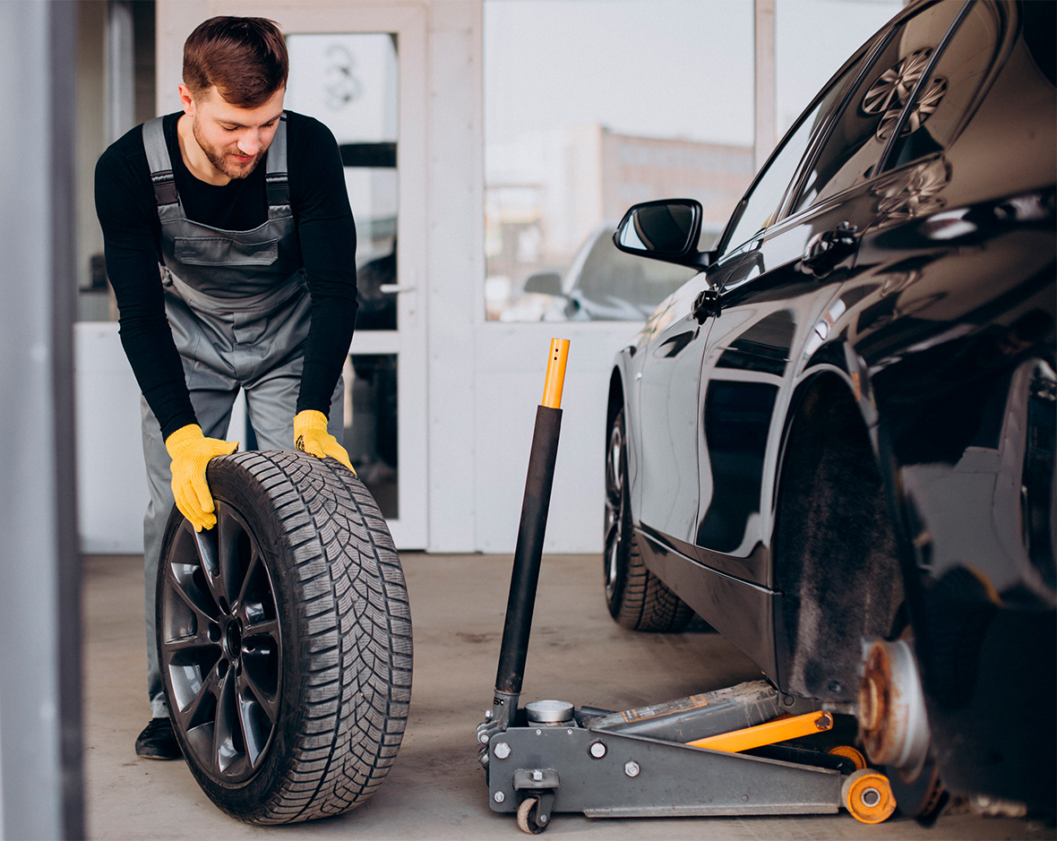 Car-mechanic Changing Wheels Car